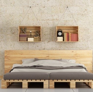 Modern bedroom with pallet bed on brick wall